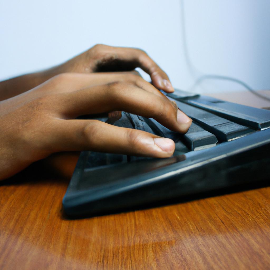 Person typing on computer desk