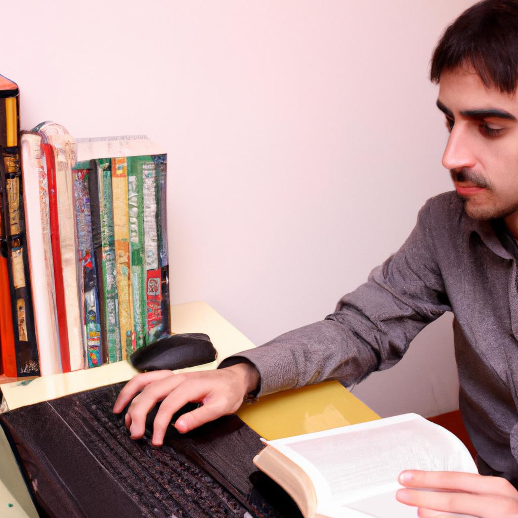 Person working with computer and books
